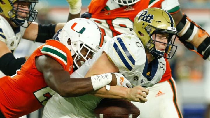 MIAMI GARDENS, FL - NOVEMBER 24: Kenny Pickett #8 of the Pittsburgh Panthers is sacked by Michael Jackson #28 of the Miami Hurricanes during the second half at Hard Rock Stadium on November 24, 2018 in Miami Gardens, Florida. (Photo by Michael Reaves/Getty Images)