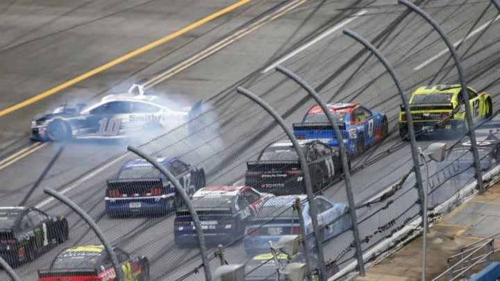 TALLADEGA, ALABAMA - JUNE 22: Aric Almirola, driver of the #10 Smithfield Ford, is involved in an on-track incident as Ryan Blaney, driver of the #12 Menards/Sylvania Ford, races to the finish line ahead of Ricky Stenhouse Jr., driver of the #47 NOS Energy Drink Chevrolet, during the NASCAR Cup Series GEICO 500 at Talladega Superspeedway on June 22, 2020 in Talladega, Alabama. (Photo by Brian Lawdermilk/Getty Images)