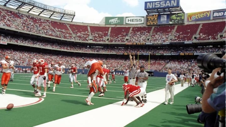24 Aug 1997: Quarterback Donovan McNabb of the Syracuse Orangemen (right) is on hands and knees in the end zone after scoring a touchdown in the Kickoff Classic game against the Wisconson Badgers at Giants Stadium in East Rutherford, New Jersey.