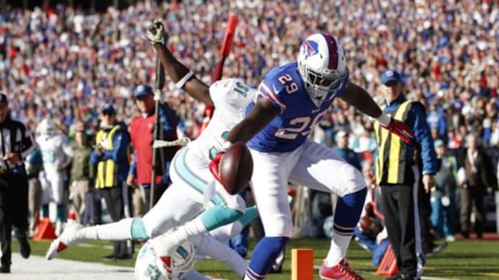 Nov 8, 2015; Orchard Park, NY, USA; Buffalo Bills running back Karlos Williams (29) runs with the ball for a touchdown as Miami Dolphins free safety Michael Thomas (31) pursues during the first half at Ralph Wilson Stadium. Mandatory Credit: Kevin Hoffman-USA TODAY Sports