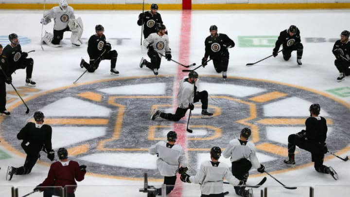 BOSTON - JUNE 11: Boston Bruins' David Krejci kneels on the ice at the center of the Bruins logo as he is surrounded by teammates during a practice in preparation for Game 7 of the 2019 Stanley Cup Finals against the St. Louis Blues at TD Garden in Boston on June 11, 2019. (Photo by John Tlumacki/The Boston Globe via Getty Images)