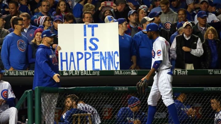 Oct 22, 2016; Chicago, IL, USA; Chicago Cubs fans hold up a sign as center fielder Dexter Fowler (24) walks back to the dugout during the fourth inning of game six of the 2016 NLCS playoff baseball series against the Los Angeles Dodgers at Wrigley Field. Mandatory Credit: Jerry Lai-USA TODAY Sports