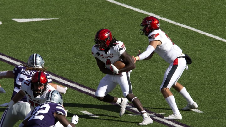 Texas Tech Red Raiders quarterback Henry Colombi (3) hands off to running back SaRodorick Thompson (4) during a game against the Kansas State Wildcats at Bill Snyder Family Football Stadium. Mandatory Credit: Scott Sewell-USA TODAY Sports