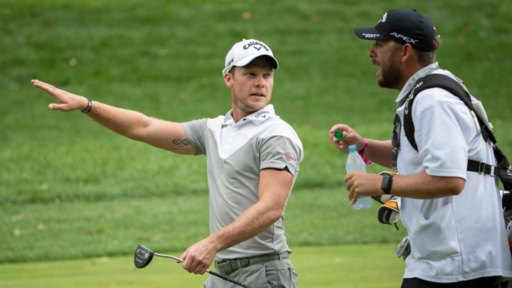 Danny Willett talks to his caddie on 9 during the final round of the Memorial Tournament at Muirfield Village Golf Club in Dublin, Ohio on Sunday, July 19, 2020.