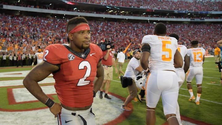 Oct 1, 2016; Athens, GA, USA; Georgia Bulldogs defensive back Maurice Smith (2) reacts in front of celebrating Tennessee Volunteers players after a game winning touchdown pass on the last play on the game during the fourth quarter at Sanford Stadium. Tennessee defeated Georgia 34-31. Mandatory Credit: Dale Zanine-USA TODAY Sports