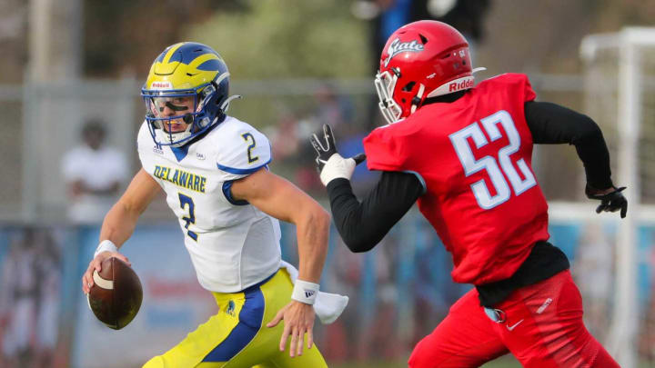 Delaware State’s Ahmed Bailey pursued Delaware quarterback Nolan Henderson in the first quarter of the Blue Hens’ 34-14 win at Alumni Stadium in Dover Saturday, April 10, 2021.Ud V Du