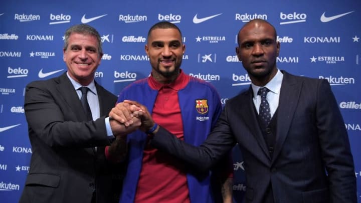 Barcelona's new Ghanaian forward Kevin-Prince Boateng poses with Barcelona's French technical secretary Eric Abidal (R) and Barcelona's Spanish vice president Jordi Mestre (L) during his official presentation at the Camp Nou stadium in Barcelona on January 22, 2019. - Boateng has vowed to make the most of his shock arrival at Barcelona, after a loan move for the journeyman from Italian side Sassuolo was sealed. (Photo by LLUIS GENE / AFP) (Photo credit should read LLUIS GENE/AFP via Getty Images)