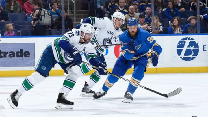 ST. LOUIS, MO - APRIL 6: Ryan O'Reilly #90 of the St. Louis Blues pressures Alexander Edler #23 of the Vancouver Canucks at Enterprise Center on April 6, 2019 in St. Louis, Missouri. (Photo by Joe Puetz/NHLI via Getty Images)
