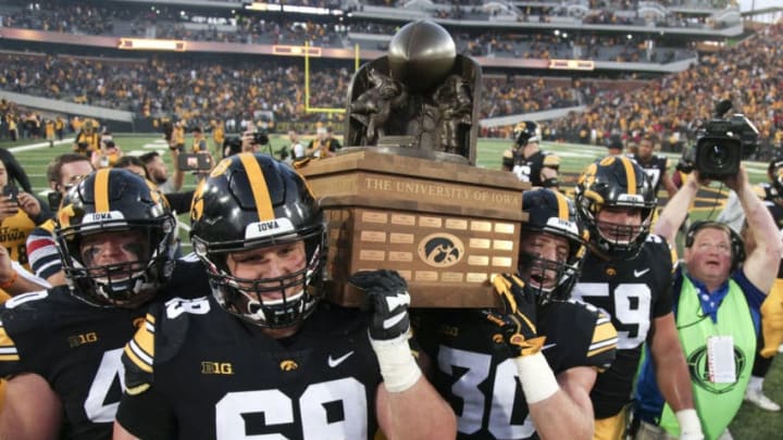 IOWA CITY, IOWA- SEPTEMBER 08: Offensive lineman Keegan Render #69 and defensive back Jake Gervase #30 of the Iowa Hawkeyes carry the Cy-Hawk trophy after the match-up against the Iowa State Cyclones on September 8, 2018 at Kinnick Stadium, in Iowa City, Iowa. (Photo by Matthew Holst/Getty Images)