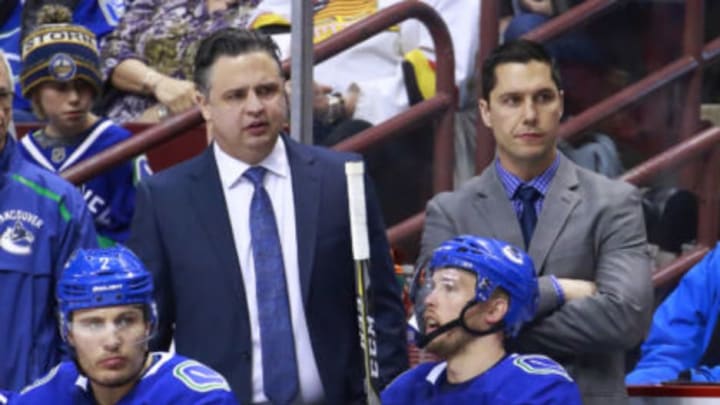 VANCOUVER, BC – MARCH 9: Head coach Travis Green (L) and assistant coach Nolan Baumgartner of the Vancouver Canucks look on from the bench during their NHL game against the Vegas Golden Knights at Rogers Arena March 9, 2019 in Vancouver, British Columbia, Canada. (Photo by Jeff Vinnick/NHLI via Getty Images)”n
