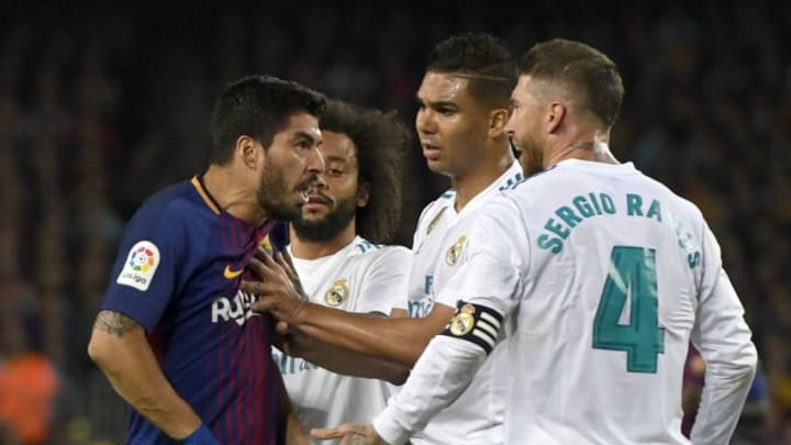 BARCELONA, SPAIN - MAY 06: Luis Suarez of Barcelona clashes with Sergio Ramos and Casemiro of Real Madrid during the La Liga match between Barcelona and Real Madrid at Camp Nou on May 6, 2018 in Barcelona, Spain. (Photo by Alex Caparros/Getty Images)