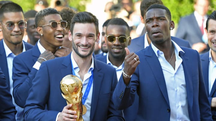 PARIS, FRANCE - JULY 16: France Captain Hugo Lloris and Paul Pogba react as he holds the trophy as French President Emmanuel Macron receives the France football team during a ceremony at the Elysee Palace on July 16, 2018 in Paris, France. France beat Croatia in the 2018 World Cup Final in Russia. (Photo by Aurelien Meunier/Getty Images)