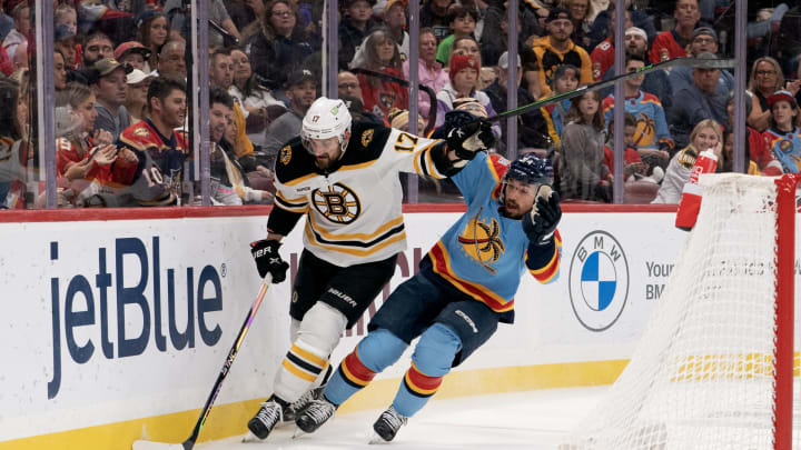 Jan 28, 2023; Sunrise, Florida, USA; Boston Bruins left wing Nick Foligno (17) and Florida Panthers left wing Ryan Lomberg (94) battle for position behind the net during the first period at FLA Live Arena. Mandatory Credit: Jason Mowry-USA TODAY Sports