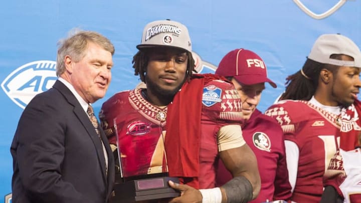 Dec 6, 2014; Charlotte, NC, USA; ACC commissioner John Swofford shakes hands with MVP Florida State Seminoles running back Dalvin Cook (4) after defeating the Georgia Tech Yellow Jackets at Bank of America Stadium. FSU defeated Georgia Tech 37-35. Mandatory Credit: Jeremy Brevard-USA TODAY Sports