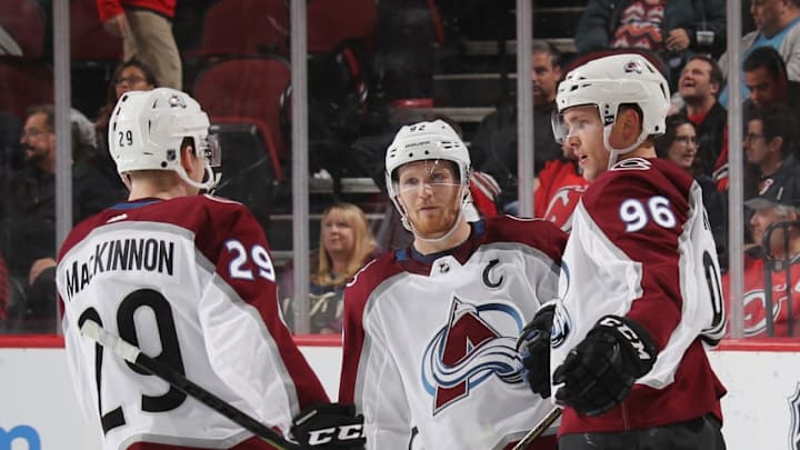 NEWARK, NEW JERSEY - OCTOBER 18: Mikko Rantanen #96 of the Colorado Avalanche (r) celebrates his empty net goal against the New Jersey Devils and is joined by Nathan MacKinnon #29 (l) and Nathan MacKinnon #29 (c) at the Prudential Center on October 18, 2018 in Newark, New Jersey. The Avalanche defeated the Devils 5-3. (Photo by Bruce Bennett/Getty Images)
