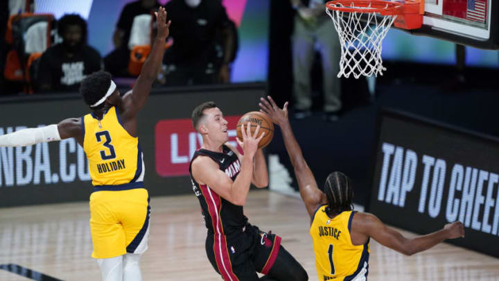 Duncan Robinson #55 of the Miami Heat drives to the basket against Aaron Holiday #3 and forward T.J. Warren #1 of the Indiana Pacers in the first half(Photo by Ashley Landis-Pool/Getty Images)