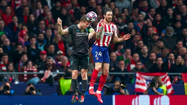 MADRID, SPAIN - FEBRUARY 18: Sime Vrsaljko of Atletico de Madrid competes for the ball with James Milner of Liverpool FC during the UEFA Champions League round of 16 first leg match between Atletico Madrid and Liverpool FC at Wanda Metropolitano on February 18, 2020 in Madrid, Spain. (Photo by Mateo Villalba/Quality Sport Images/Getty Images)