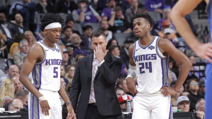 SACRAMENTO, CA – MARCH 21: Head coach Dave Joerger of the Sacramento Kings coaches De’Aaron Fox #5 and Buddy Hield #24 against the Dallas Mavericks on March 21, 2019 at Golden 1 Center in Sacramento, California. NOTE TO USER: User expressly acknowledges and agrees that, by downloading and or using this photograph, User is consenting to the terms and conditions of the Getty Images Agreement. Mandatory Copyright Notice: Copyright 2019 NBAE (Photo by Rocky Widner/NBAE via Getty Images)