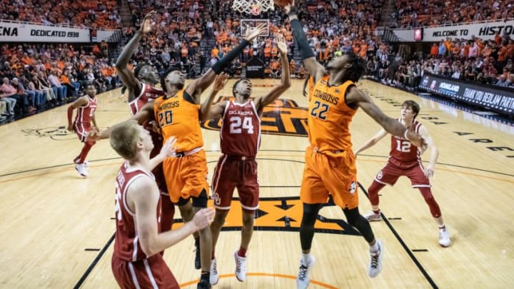 Feb 22, 2020; Stillwater, Oklahoma, USA; Oklahoma State Cowboys forward Kalib Boone (22) shoots the ball while defended by Oklahoma Sooners guard Jamal Bieniemy (24) during the second half at Gallagher-Iba Arena. Mandatory Credit: Rob Ferguson-USA TODAY Sports