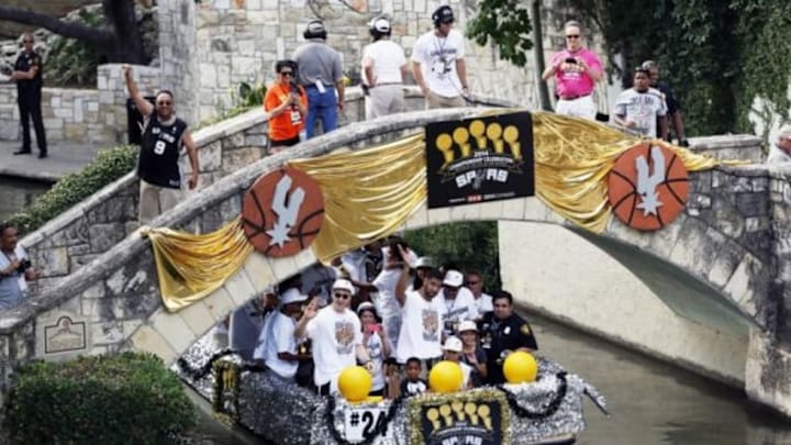 Jun 18, 2014; San Antonio, TX, USA; San Antonio Spurs forward Tim Duncan (front middle) waves to the fans during the NBA championship parade at San Antonio River Walk. Mandatory Credit: Soobum Im-USA TODAY Sports