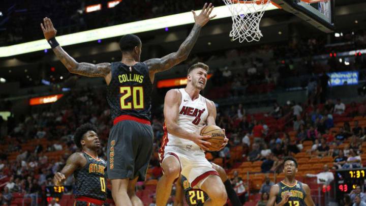 Meyers Leonard #0 of the Miami Heat attempts a layup against John Collins #20 of the Atlanta Hawks (Photo by Michael Reaves/Getty Images)