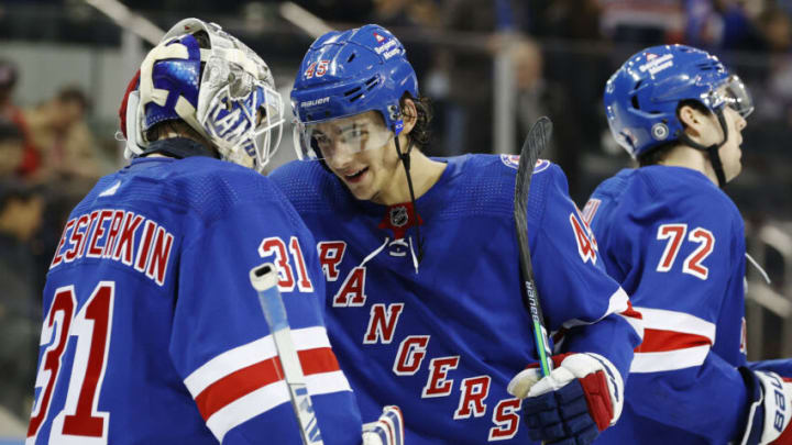 NEW YORK, NEW YORK - APRIL 16: Braden Schneider #45 reacts with Igor Shesterkin #31 of the New York Rangers after Shesterkin recorded a shutout during the third period against the Detroit Red Wings at Madison Square Garden on April 16, 2022 in New York City. The Rangers won 4-0. (Photo by Sarah Stier/Getty Images)