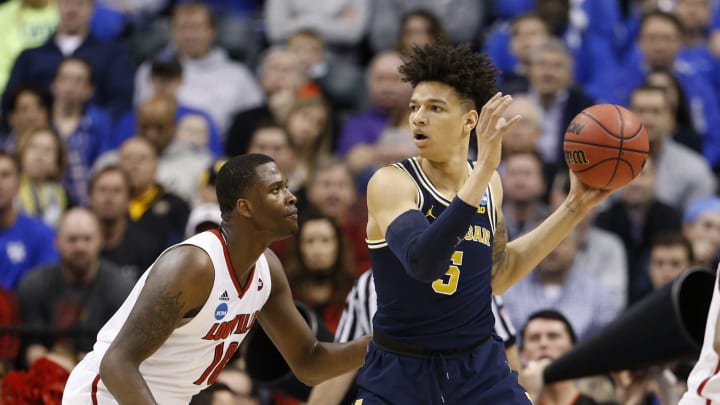 Mar 19, 2017; Indianapolis, IN, USA; Michigan Wolverines forward D.J. Wilson (5) is defended by Louisville Cardinals forward Jaylen Johnson (10) during the first half in the second round of the 2017 NCAA Tournament at Bankers Life Fieldhouse. Mandatory Credit: Brian Spurlock-USA TODAY Sports