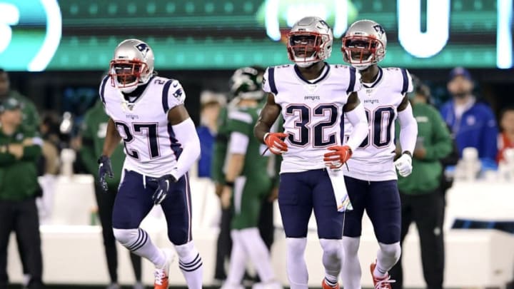 EAST RUTHERFORD, NEW JERSEY - OCTOBER 21: J.C. Jackson #27, Devin McCourty #32 and Jason McCourty #30 of the New England Patriots look on against the New York Jets at MetLife Stadium on October 21, 2019 in East Rutherford, New Jersey. (Photo by Steven Ryan/Getty Images)