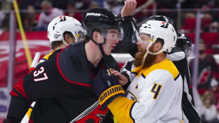 May 17, 2021; Raleigh, North Carolina, USA; Carolina Hurricanes right wing Andrei Svechnikov (37) and Nashville Predators defenseman Ryan Ellis (4) have word during the third period in game one of the first round of the 2021 Stanley Cup Playoffs at PNC Arena. Mandatory Credit: James Guillory-USA TODAY Sports