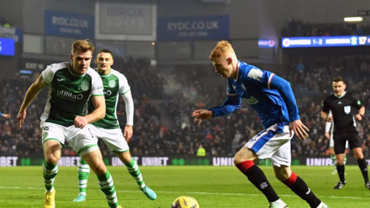 GLASGOW, SCOTLAND - DECEMBER 15: Adam Devine of Rangers runs at Chris Cadden of Hibernian during the Cinch Scottish Premiership match between Rangers FC and Hibernian FC at on December 15, 2022 in Glasgow, Scotland. (Photo by Mark Runnacles/Getty Images)