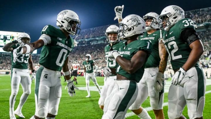 Michigan State's Jayden Reed, center, celebrates with teammates after his punt return for a touchdown against Western Kentucky during the first quarter on Saturday, Oct. 2, 2021, at Spartan Stadium in East Lansing.211002 Msu Wku Fb 062a