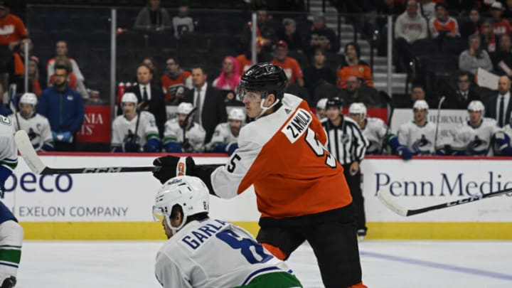 Oct 17, 2023; Philadelphia, Pennsylvania, USA; Philadelphia Flyers defenseman Egor Zamula (5) shoots and scores in the first period against the Vancouver Canucks at the Wells Fargo Center. Mandatory Credit: John Geliebter-USA TODAY Sports