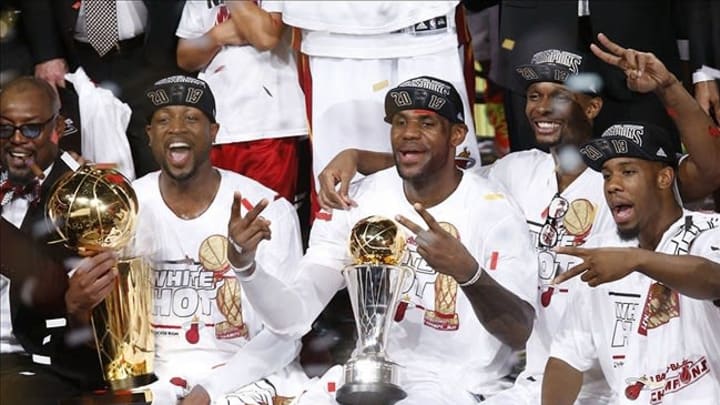 Jun 20, 2013; Miami, FL, USA; Miami Heat shooting guard Dwyane Wade (left), LeBron James (center) and Chris Bosh (right) celebrate after game seven in the 2013 NBA Finals at American Airlines Arena. Miami defeated the San Antonio Spurs 95-88 to win the NBA Championship. Mandatory Credit: Derick E. Hingle-USA TODAY Sports