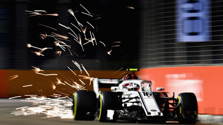 SINGAPORE - SEPTEMBER 14: Sparks fly behind Charles Leclerc of Monaco driving the (16) Alfa Romeo Sauber F1 Team C37 Ferrari on track during practice for the Formula One Grand Prix of Singapore at Marina Bay Street Circuit on September 14, 2018 in Singapore. (Photo by Clive Mason/Getty Images)