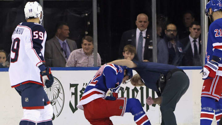 NEW YORK, NEW YORK - OCTOBER 23: Filip Chytil #72 of the New York Rangers is injured and attended to by trainer Jim Ramsey during the first period against the Columbus Blue Jackets at Madison Square Garden on October 23, 2022 in New York City. (Photo by Bruce Bennett/Getty Images)