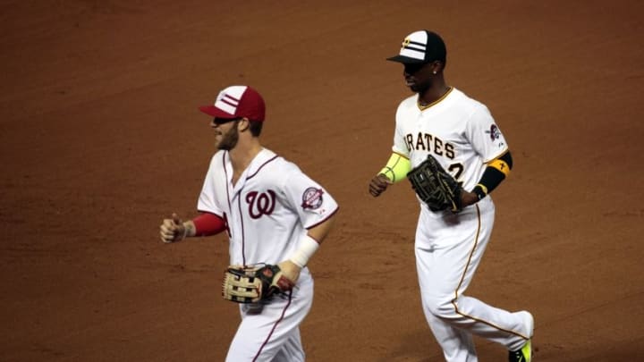 Jul 14, 2015; Cincinnati, OH, USA; National League outfielder Bryce Harper (34) of the Washington Nationals and National League outfielder Andrew McCutchen (22) of the Pittsburg Pirates run off the field during the 2015 MLB All Star Game at Great American Ball Park. Mandatory Credit: David Kohl-USA TODAY Sports