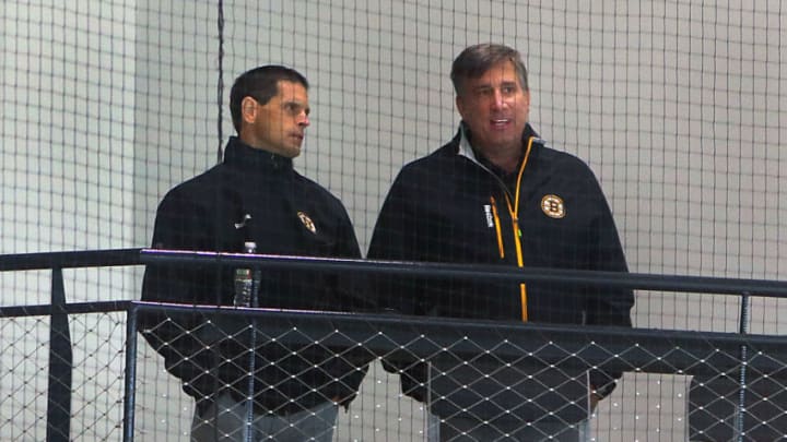 BOSTON - SEPTEMBER 24: Boston Bruins general manager Don Sweeney, left, chats with Bruins president Cam Neely as they watch the camp from the stands during training camp at Warrior Ice Arena in Boston on Sept. 24, 2016. (Photo by John Tlumacki/The Boston Globe via Getty Images)