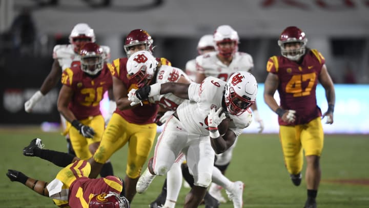 LOS ANGELES, CA – OCTOBER 9: Tavion Thomas #9 of the Utah Utes breaks the tackle of Chase Williams #7 of the USC Trojans on second half touchdown run during a college football game at Los Angeles Memorial Coliseum October 9, 2021 in Los Angeles, California. (Photo by Denis Poroy/Getty Images)