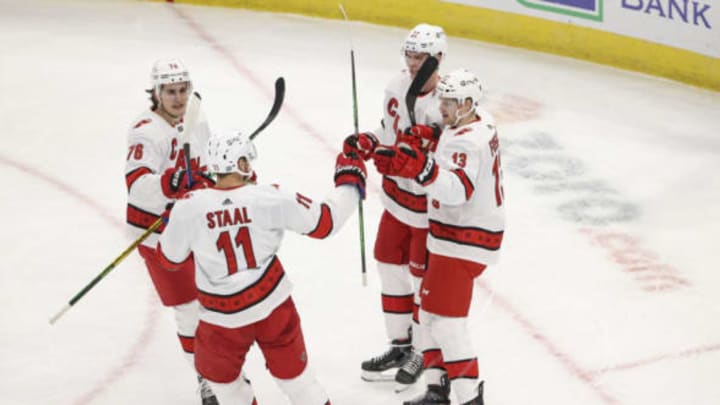 Feb 2, 2021; Chicago, Illinois, USA; Carolina Hurricanes left wing Warren Foegele (13) celebrates with teammates after scoring against the Chicago Blackhawks during the first period at United Center. Mandatory Credit: Kamil Krzaczynski-USA TODAY Sports