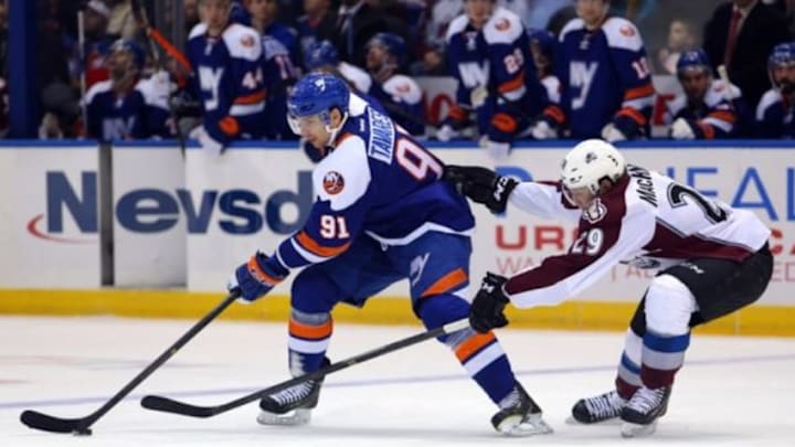 Feb 8, 2014; Uniondale, NY, USA; New York Islanders center John Tavares (91) controls the puck in front of Colorado Avalanche center Nathan MacKinnon (29) during the second period of a game at Nassau Veterans Memorial Coliseum. Mandatory Credit: Brad Penner-USA TODAY Sports Feb 8, 2014; Uniondale, NY, USA; New York Islanders center John Tavares (91) controls the puck in front of Colorado Avalanche center Nathan MacKinnon (29) during the second period of a game at Nassau Veterans Memorial Coliseum. Mandatory Credit: Brad Penner-USA TODAY Sports