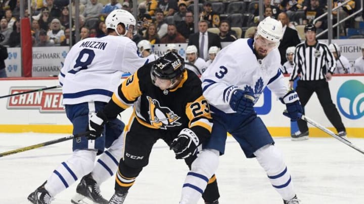 Pittsburgh Penguins left wing Brock McGinn (23) takes the puck between Toronto Maple Leafs defenders Jake Muzzin (8) and Justin Holl (3): Philip G. Pavely-USA TODAY Sports