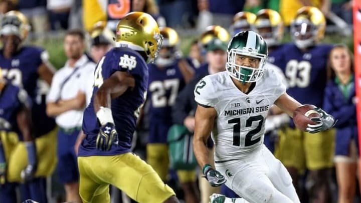 Sep 17, 2016; South Bend, IN, USA; Michigan State Spartans wide receiver R.J. Shelton (12) runs the ball against Notre Dame Fighting Irish defensive back Nick Coleman (24) during the second half a game at Notre Dame Stadium. Mandatory Credit: Mike Carter-USA TODAY Sports