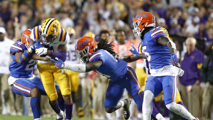 BATON ROUGE, LOUISIANA - OCTOBER 12: Ja'Marr Chase #1 of the LSU Tigers is tackled by Brad Stewart Jr. #2 of the Florida Gators during the fourth quarter at Tiger Stadium on October 12, 2019 in Baton Rouge, Louisiana. (Photo by Marianna Massey/Getty Images)