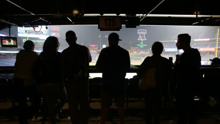 PHILADELPHIA, PA - MAY 12: Fans stand under an overhang during a rain delay before a game between the Philadelphia Phillies and the New York Mets at Citizens Bank Park on May 12, 2018 in Philadelphia, Pennsylvania. The game was later postponed due to weather. (Photo by Hunter Martin/Getty Images)