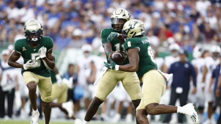 Sep 3, 2022; Tampa, Florida, USA; South Florida Bulls quarterback Gerry Bohanon (11) hands the ball off to running back Jaren Mangham (0) against the Brigham Young Cougars during the first half at Raymond James Stadium. Mandatory Credit: Douglas DeFelice-USA TODAY Sports