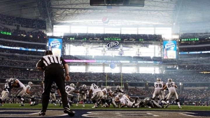 Nov 28, 2013; Arlington, TX, USA; Oakland Raiders quarterback Matt McGloin (14) fumbles the ball during the first quarter of the game against the Dallas Cowboys during a NFL football game on Thanksgiving at AT&T Stadium. Photo Credit: USA Today Sports