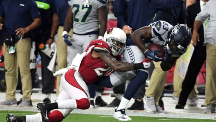 GLENDALE, AZ – SEPTEMBER 30: Linebacker Deone Bucannon #20 of the Arizona Cardinals tackles wide receiver David Moore #83 of the Seattle Seahawks during the first half at State Farm Stadium on September 30, 2018 in Glendale, Arizona. (Photo by Norm Hall/Getty Images)