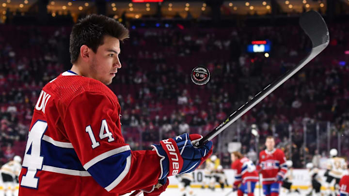 MONTREAL, QC – APRIL 24: Nick Suzuki #14 of the Montreal Canadiens juggles the puck during warmups prior to the game against the Boston Bruins at Centre Bell on April 24, 2022 in Montreal, Canada. The Boston Bruins defeated the Montreal Canadiens 5-3. (Photo by Minas Panagiotakis/Getty Images)