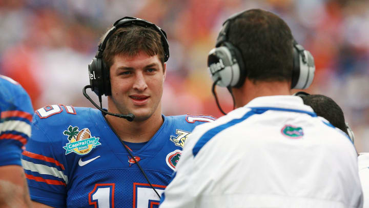 ORLANDO, FL – JANUARY 01: Quarterback Tim Tebow #15 of the Florida Gators talks with head coach Urban Meyer during a stoppage in play while taking on the Michigan Wolverines in the Capital One Bowl at Florida Citrus Bowl on January 1, 2008 in Orlando, Florida. Michigan defeated Florida 41-35. (Photo by Doug Benc/Getty Images)