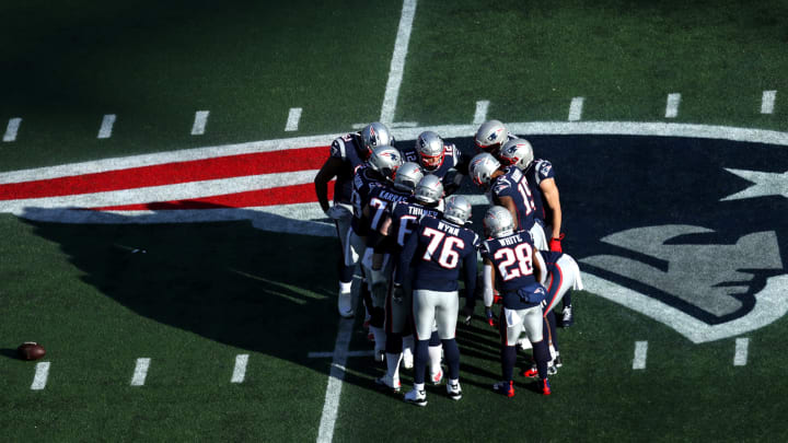 FOXBOROUGH, MASSACHUSETTS – DECEMBER 29: Tom Brady #12 of the New England Patriots huddles with teammates during the game against the Miami Dolphins over the Patriots logo at Gillette Stadium on December 29, 2019 in Foxborough, Massachusetts. (Photo by Maddie Meyer/Getty Images)